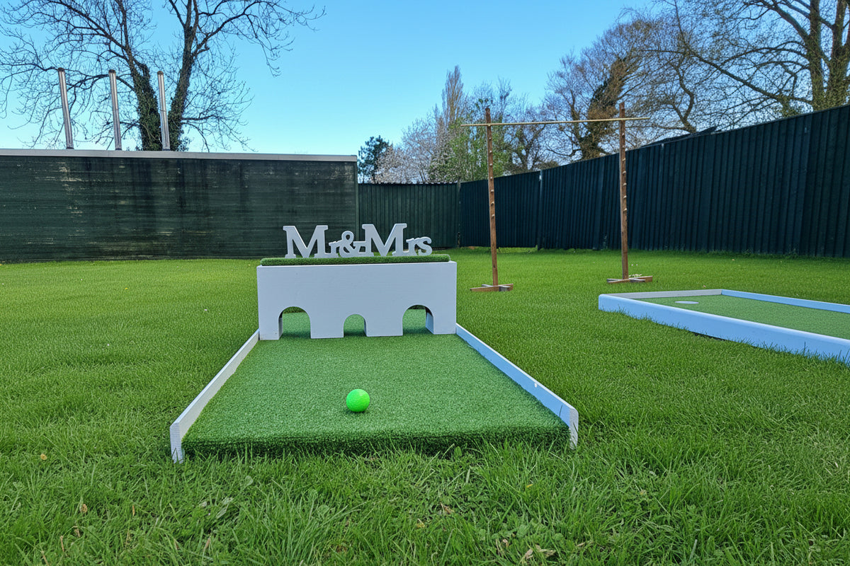 Mini golf course with a green ball and 'M&amp;M's' branding in a grassy area. Briars Hall Hotel, Latham