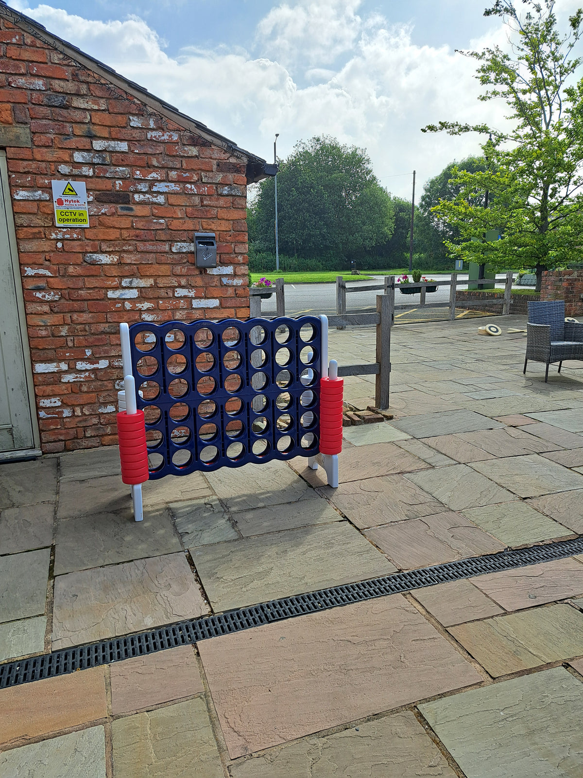 A giant 4 in a Row game with red and blue discs on a patio at Charnock Farm, Chorley