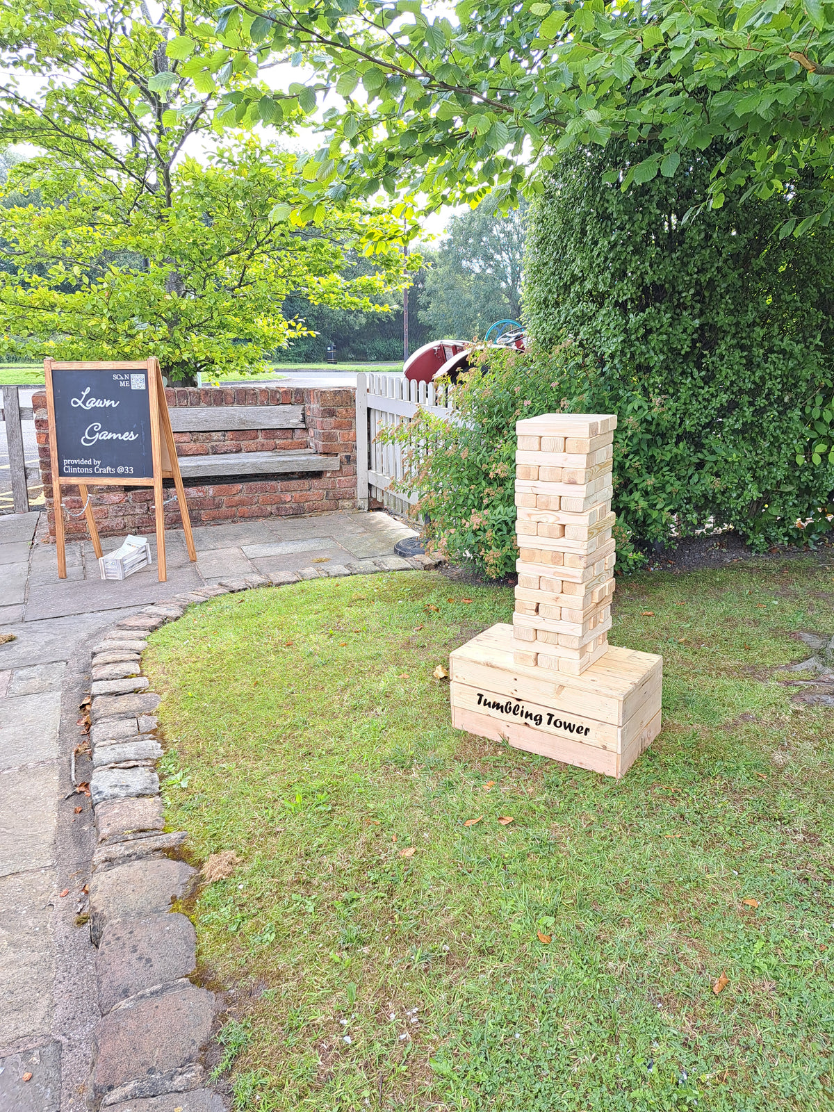 Giant tumbling towers on a grassy area with trees in the background. Charnock Farm, Chorley