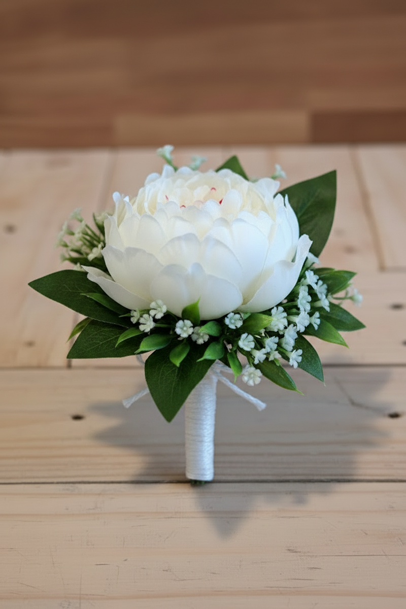 Grooms button hole with a single white peony and foliage, tied with white string